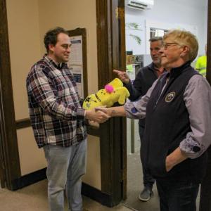 Josh Faherty and Lisa Johnson shake hands. 