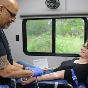 Phlebotomist Angel Martinez, left, begins drawing Arisa Whynot's blood during the Wareham Police Department's blood drive on Saturday, May 9. Photos by Grace Roche