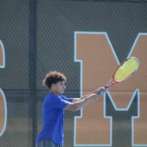 Thomas DeCanto hits it back to his opponent. 