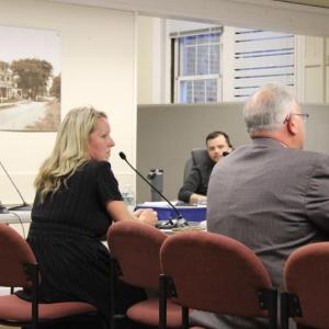 Jennifer McHugh sits next to Christian Consoletti during the meeting. 
