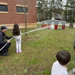 Fire! Students help put out fake fires with Wareham Fire Department.