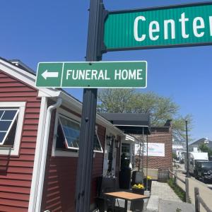 A sign in front of the Pour Farm Tavern points to the Wareham Village Funeral Home. Photos by Brandy Muz