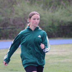 Dashing down the track, Ava Ostiguy practices sprinting.