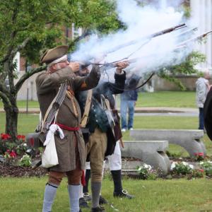 The minutemen fire their rifles.