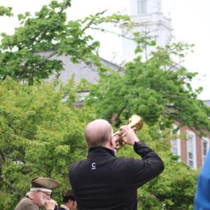 Christopher Berg plays Taps in front of Town Hall.