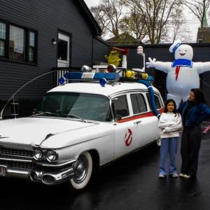 PINKLIDS makes a pit stop. Lead singer Amber Lawson, left, and her little sister with the ghost busters vehicle. 