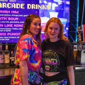 Olivia Vaccaro and Lily Shepley working donned in 80's gear.