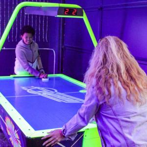 LJ Burdette and Terisa Bumpus dueling in air hockey.