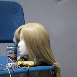 One of the show's many wigs sitting on a mannequin at rehearsal.