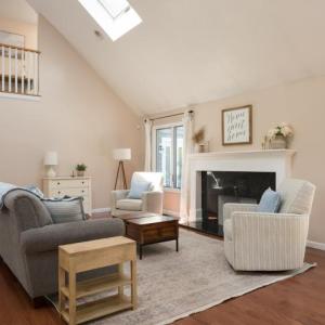 Living room with cathedral ceiling and wood burning fire place