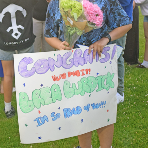 A sign supporting a graduate. 