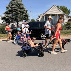 residents walk down the road for the parade