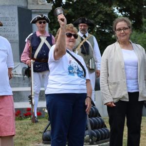 Claire Smith, center, rings a freedom bell. 