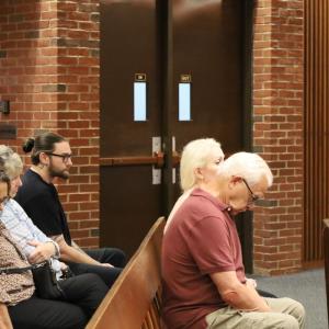 Chadwick's family members and Select Board member Judith Whiteside, center in the leftmost row, watch the proceedings. 