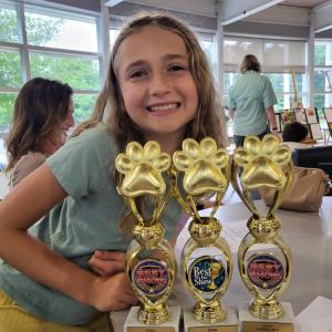 Nova Lomp with her three trophies for artwork, writing and "best in show."