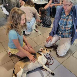 Beth Schweitzer, right, brought her comfort dog, Dickens, to the awards ceremony at the Gleason Family YMCA.