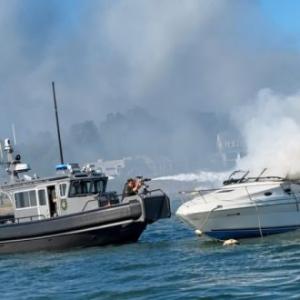 A Wareham Department of Natural Resources vessel douses the burning boat with a water cannon on Saturday, Aug. 8. Photo source: Wareham Department of Natural Resources