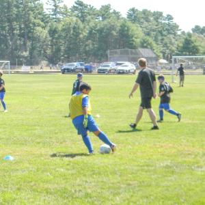 A player passes the ball in a warmup drill.