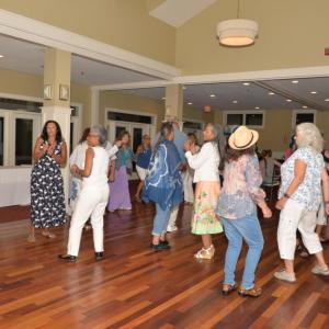 Classmates dance together.