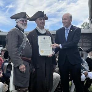 Keating presents the Minutemen with an official recognition certificate from the House.