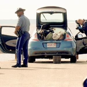 Police searching the vehicle at Swifts beach. Photos by David Curran
