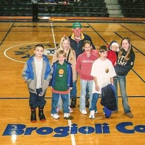 Brogioli with seven of his 17 grandchildren on the basketball court that was named in his honor.