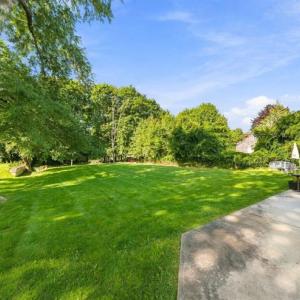Large backyard lawn with mature trees behind 17 Beeden Road in Westport, MA