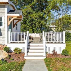 Stone walkway and white railed steps leading up to the deck at 226 Sanford Road in Westport, MA