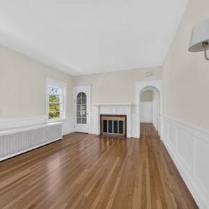 Unit 2 living room with hardwood floors, wainscoting and a fireplace at 370 Maple Street, New Bedford