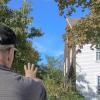 Carlston Wood stands outside of the famously haunted Fearing Tavern. Photo by Brandy Muz