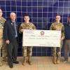 Col. Matt Stanton and JRTOC cadets Aaron Legg and Emily Morais accept a donation toward the town's Veterans Day Parade. Photo source: Nora Bicki